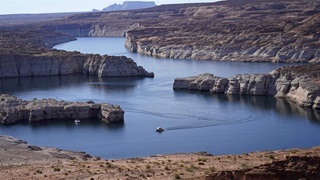 In this Saturday, July 31, 2021 file photo, a boat cruises along Lake Powell near Page, Ariz. 