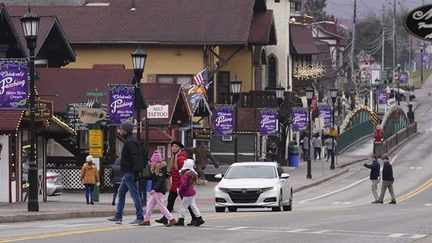 People cross the street in downtown Helen, Ga., Friday, Jan. 21, 2022. Helen is located in White County, in the foothills of the Blue Ridge Mountains in northeast Georgia, where officials were stunned when the 2020 census said the county had 28,003 residents.
