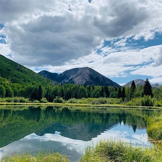 The peaks of the La Sal Mountains rise above Warner Lake on the Manti-La Sal National Forest east of Moab.