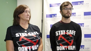 Adam Hergenreder, right, and his mother Polly, attend a news conference where their attorney announced the filing of a civil lawsuit against e-cigarette maker Juul on Hergenreder's behalf Friday, Sept. 13, 2019, in Chicago. 