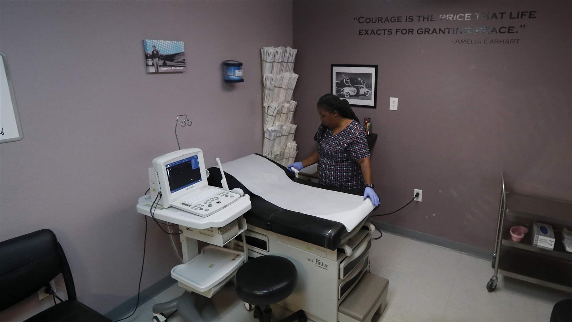 In this Sept. 4, 2019 file photo, Director of Clinical Services Marva Sadler, prepares the operating room at the Whole Woman's Health clinic in Fort Worth, Texas.