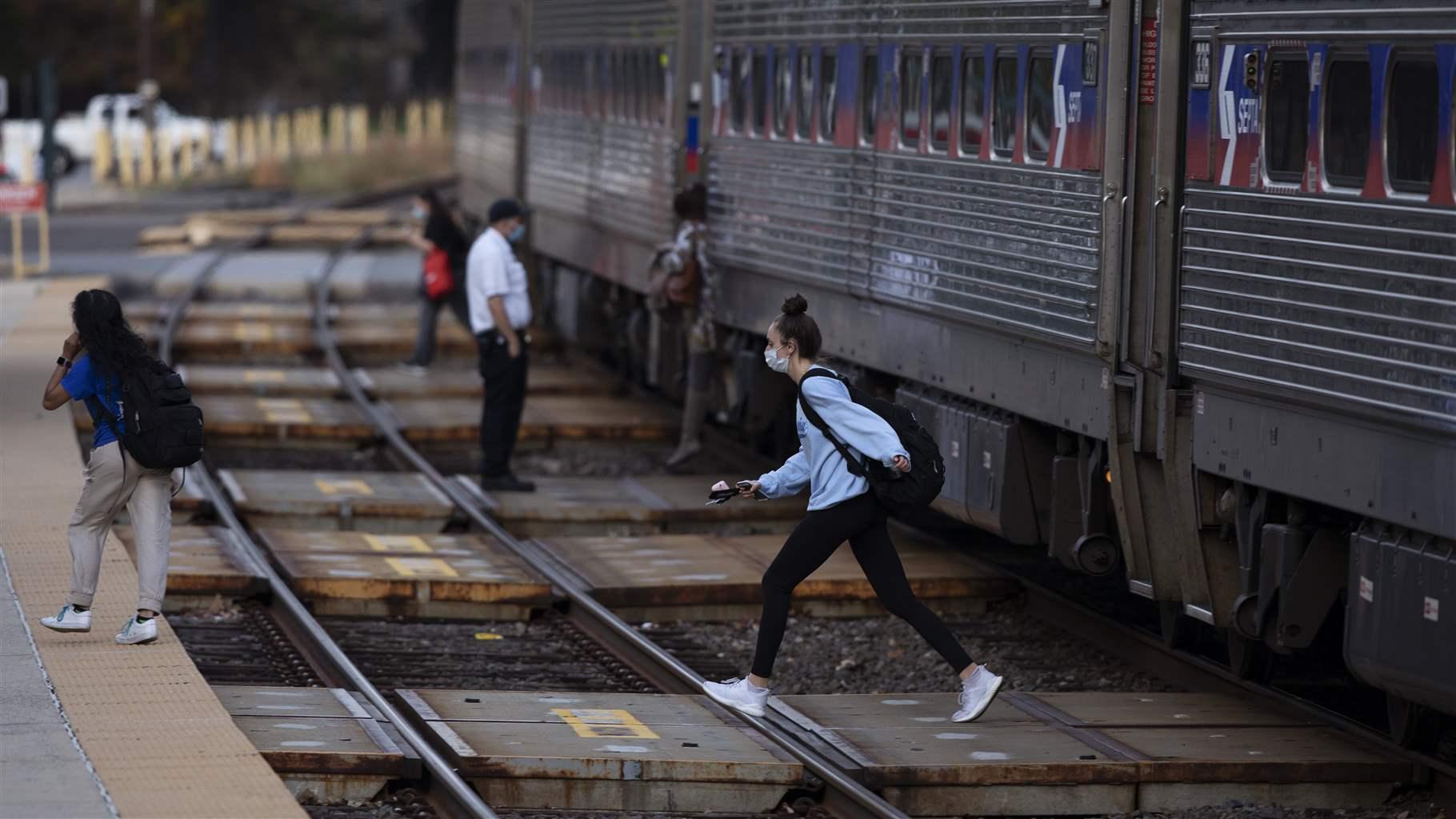 Passengers cross a SEPTA track