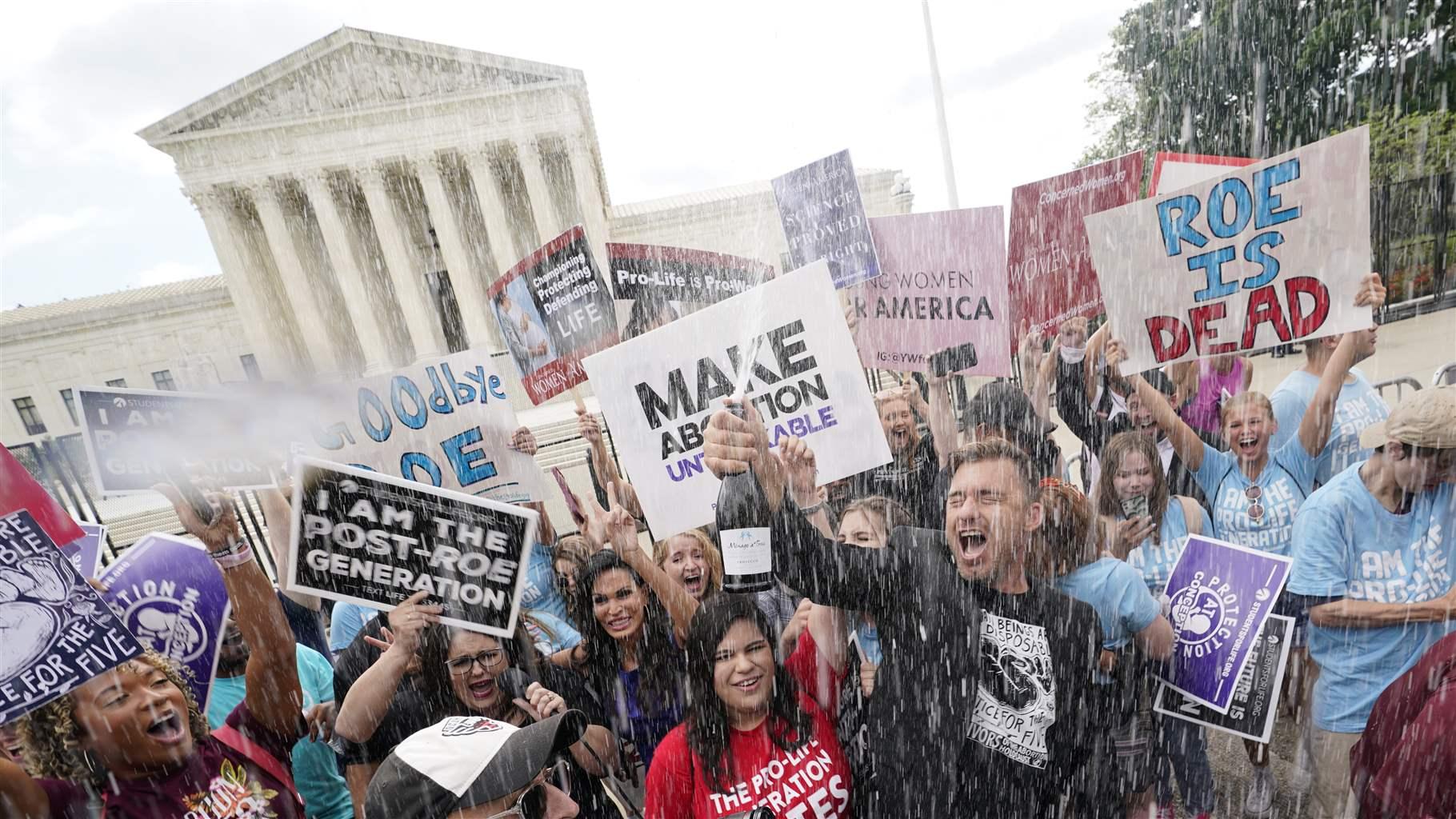A celebration outside the Supreme Court, Friday, June 24, 2022, in Washington. 