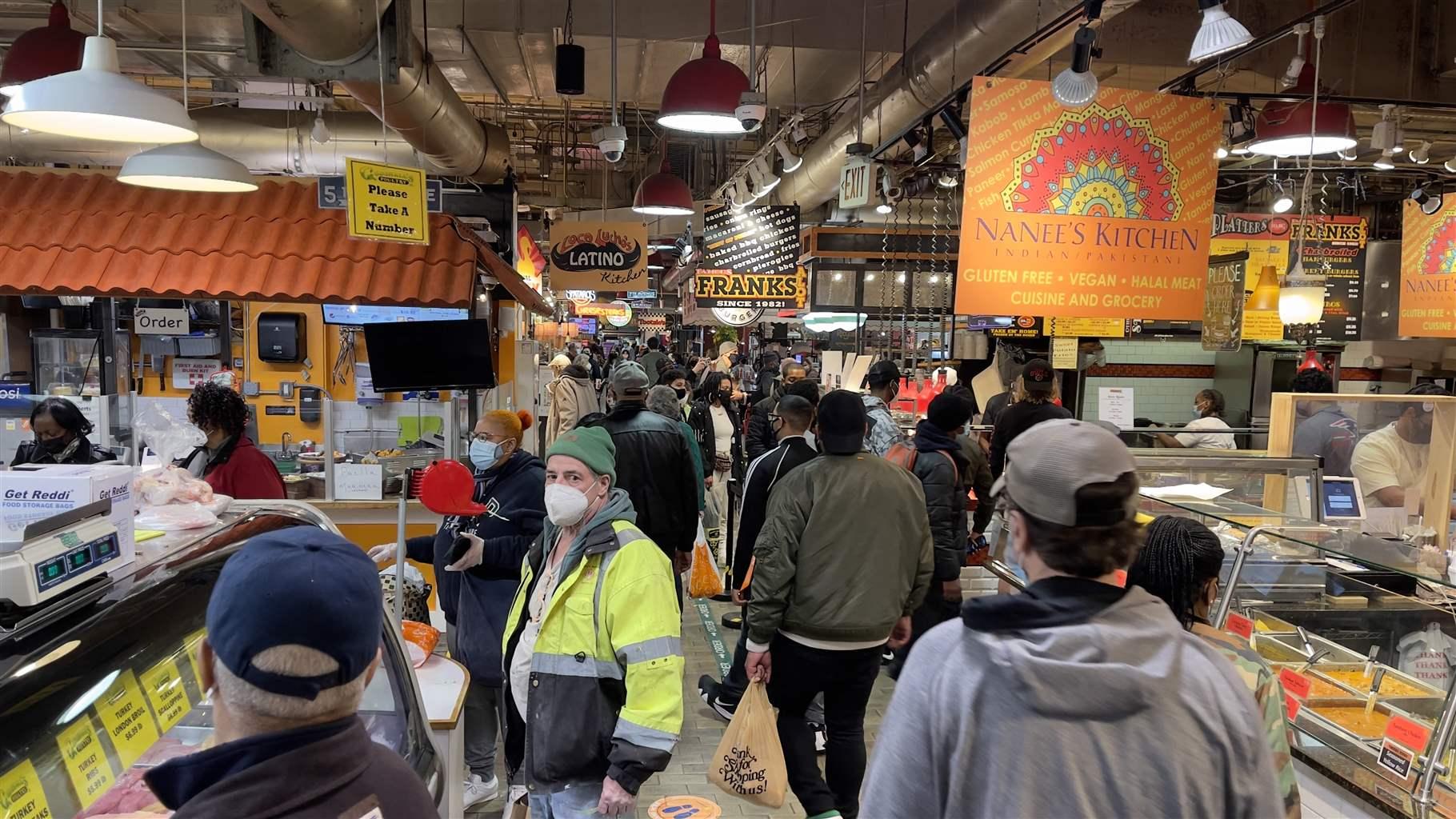 Shoppers are seen gathering inside the indoor Farmer's Market (since 1892) in Philadelphia, Pennsylvania, on March 19, 2021 amid the Coronavirus pandemic restrictions.