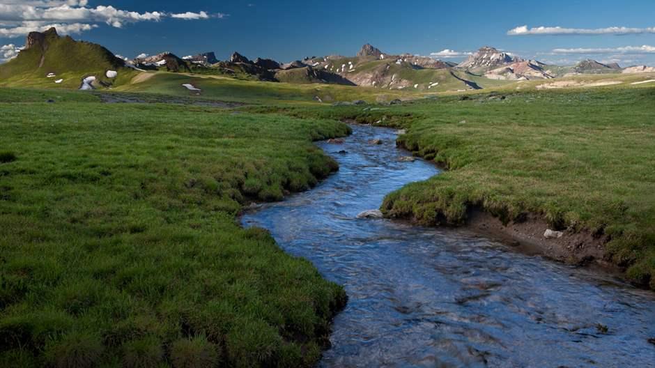 The Cimarron River in southwestern Colorado’s Uncompahgre Wilderness. Rivers within designated wilderness areas in Colorado are protected as Outstanding National Resource Waters (ONRWs) and preserved for future generations to enjoy, river, stream, grasses, water, mountains, hills, blue, sky, clouds, landscape, nature, wild, wilderness