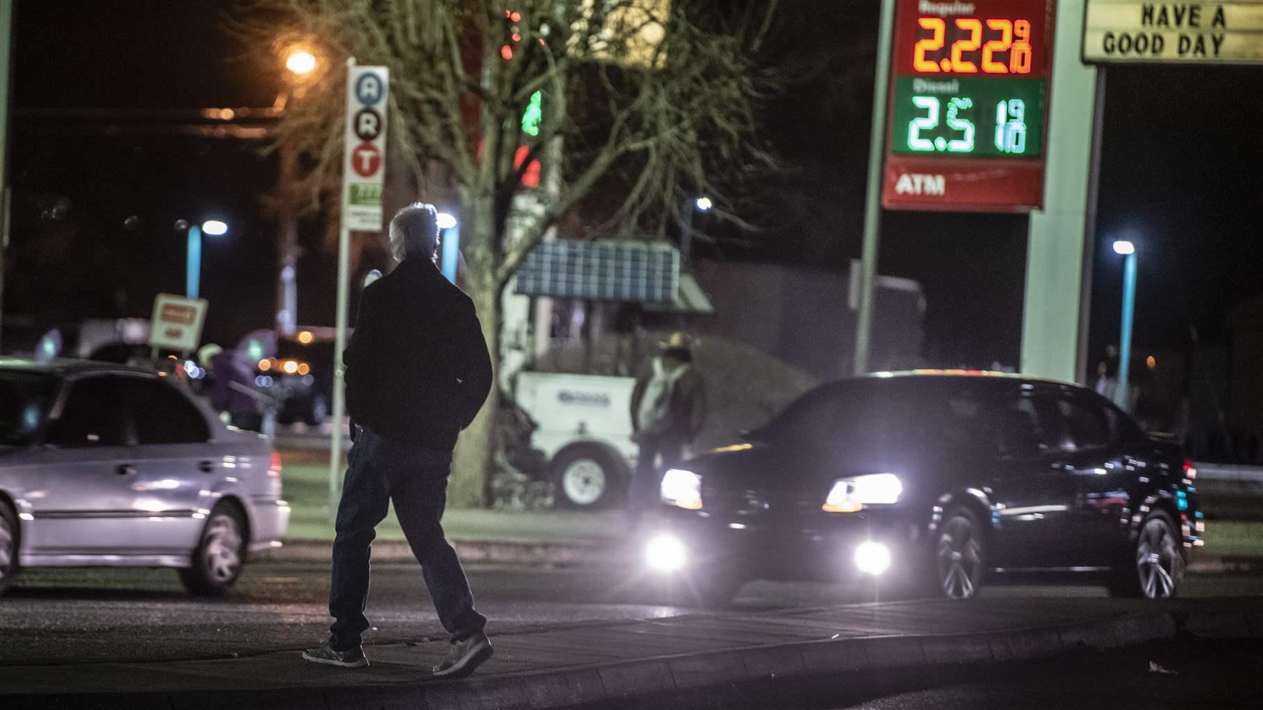A man jaywalks near Wyoming and Central Ave, Route 66 in Albuquerque, N.M., March 5, 2020.