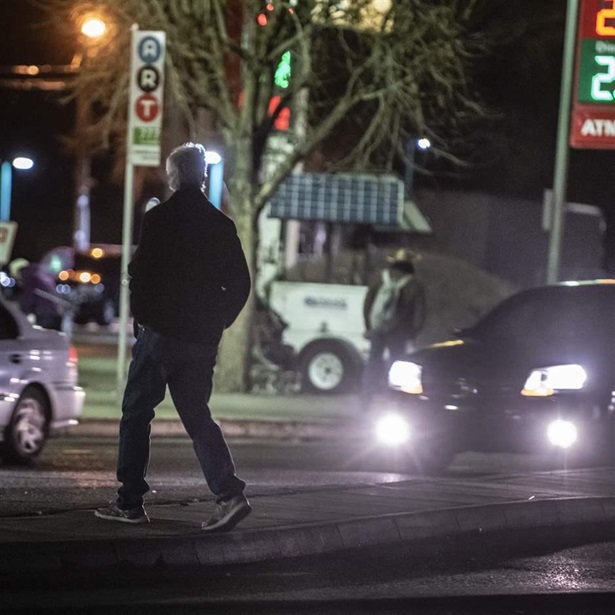 A man jaywalks near Wyoming and Central Ave, Route 66 in Albuquerque, N.M., March 5, 2020.