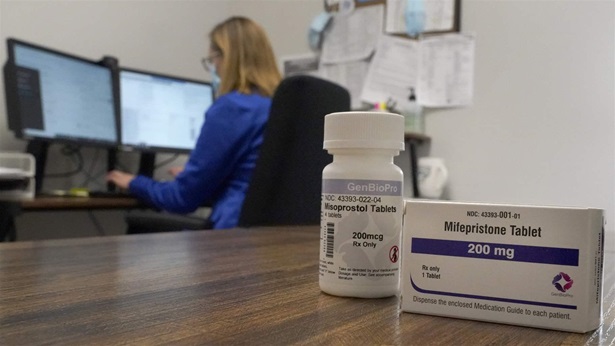 A Nurse Practitioner works in an office at a Planned Parenthood clinic where she confers via teleconference with patients seeking self-managed abortions as containers of the medication used to end an early pregnancy sits on a table nearby Friday, Oct. 29, 2021, in Fairview Heights, Ill. Women with unwanted pregnancies are increasingly considering getting abortion pills by mail.
