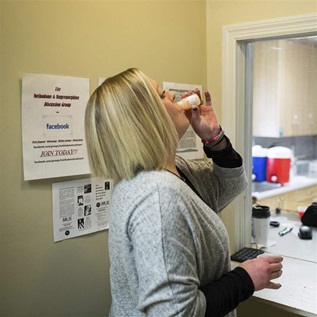 In this March 8, 2017 photo, Ashley Gardner, 34, takes a dose of methadone at Counseling Solutions of Chatsworth, Ga. Gardner, 34-year-old woman said her addiction started in the seventh grade when she wanted to numb the pain after she was sexually assaulted.