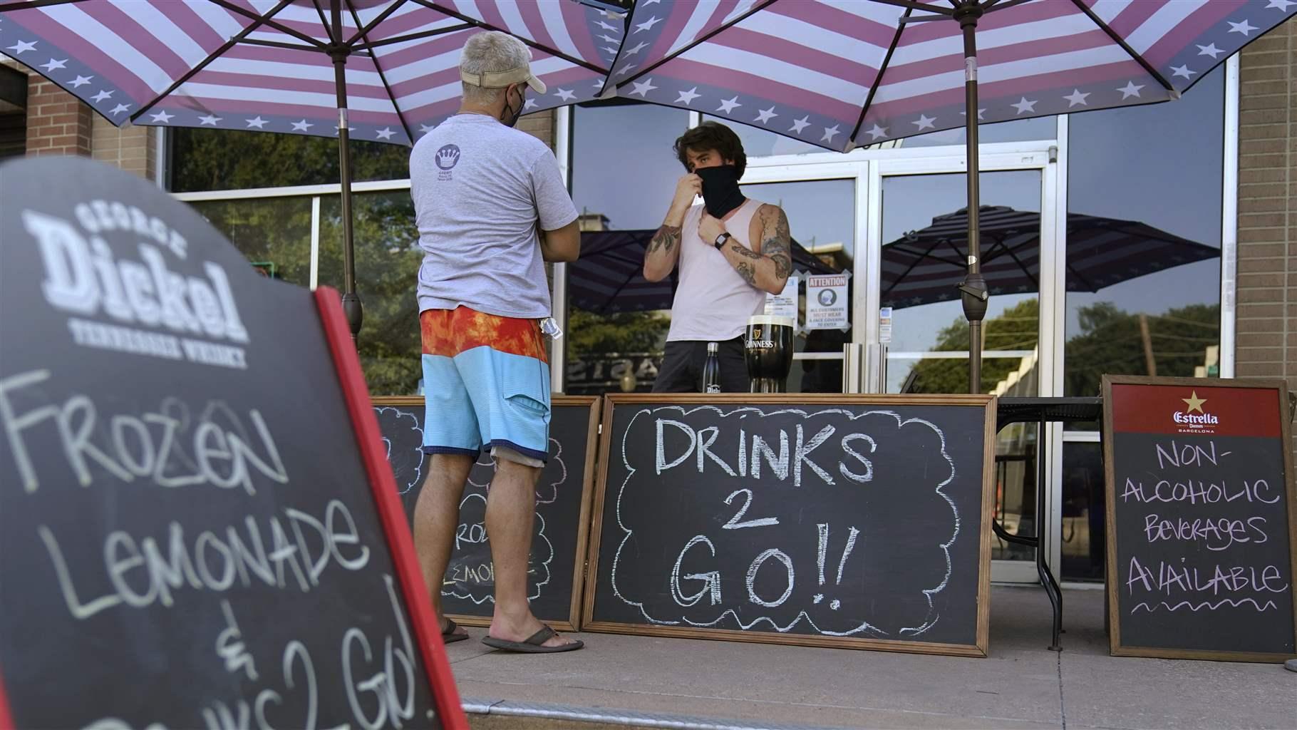 A drinks-to-go table is set up outside the Old Crow bar on Greenville Avenue in Dallas, Thursday, Aug. 13, 2020. A drinks-to-go table is set up outside the Old Crow bar on Greenville Avenue in Dallas, Thursday, Aug. 13, 2020.