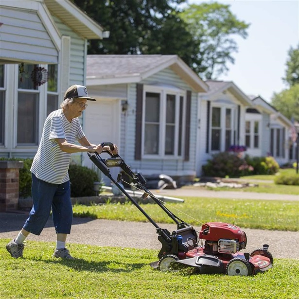 Homeowner mowing lawn