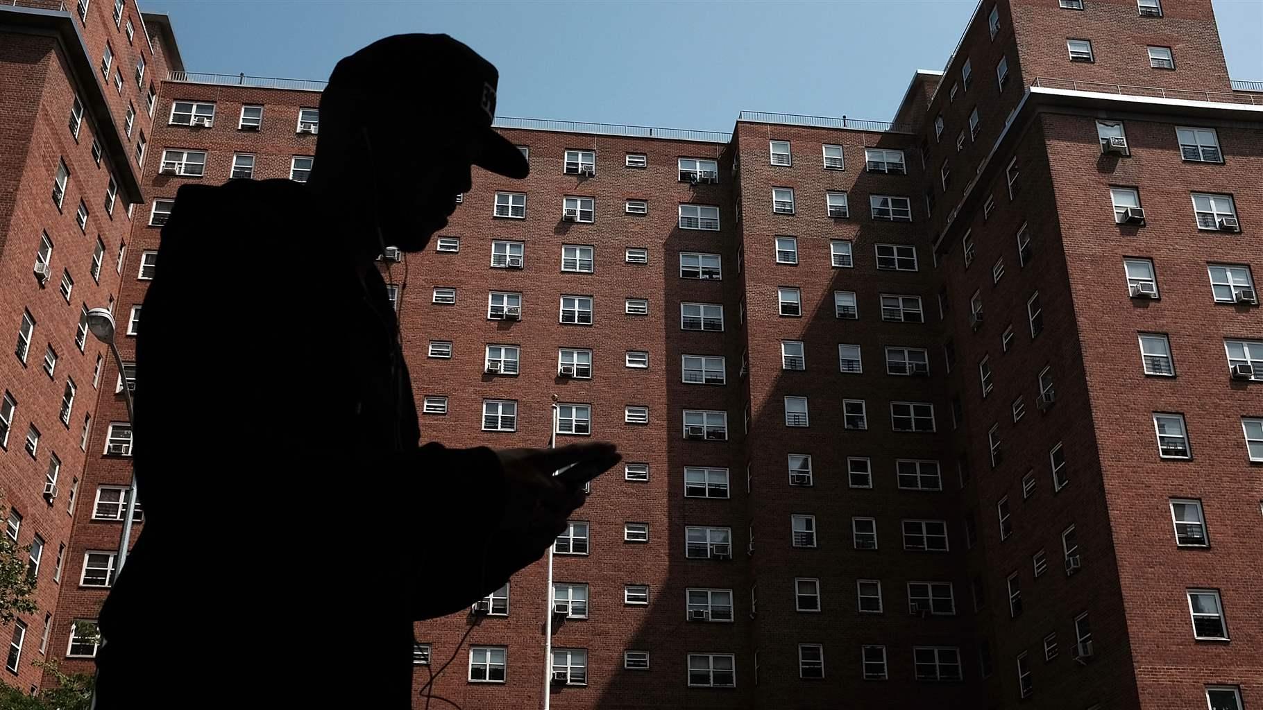 person walks by an East Harlem public housing