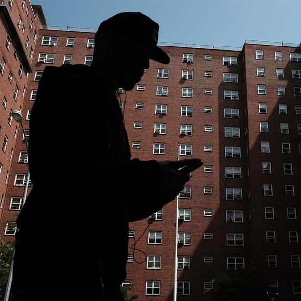 person walks by an East Harlem public housing