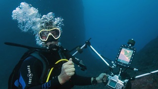 French reporter Alexis Rosenfeld tests a camera connected to a geo-tracking tablet during a diving off the coast of Marseille, on November 1, 2017 before starting his work on the aftermath of hurricane Irma on the coral reef of the French Caribbean island of Saint-Martin.