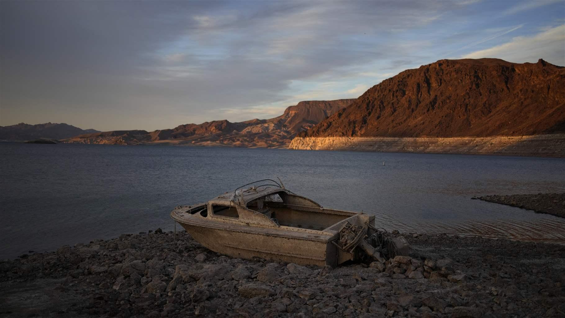A formerly sunken boat sits high and dry along the shoreline of Lake Mead at the Lake Mead National Recreation Area, on May 10, 2022, near Boulder City, Nev.