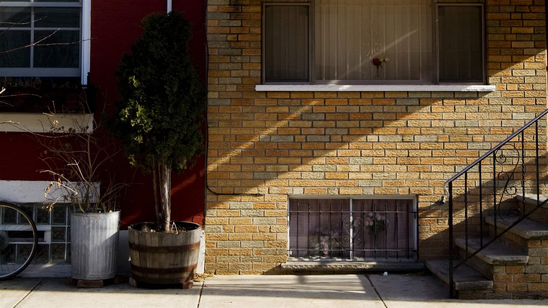 Exterior shot of a condo front building with rays of light streaming down to the right