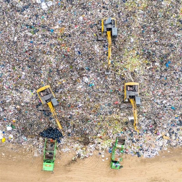Aerial shot top view Garbage trucks unload garbage to a recycle in the vicinity of the city of Bangkok, Thailand