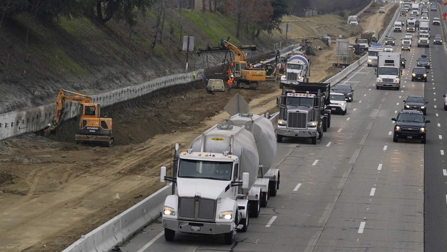 Trucks and other vehicles pass a construction zone on Highway 50 in Sacramento, Calif., Monday, Dec. 6, 2021. Trucks and other vehicles pass a construction zone on Highway 50 in Sacramento, Calif., Monday, Dec. 6, 2021.