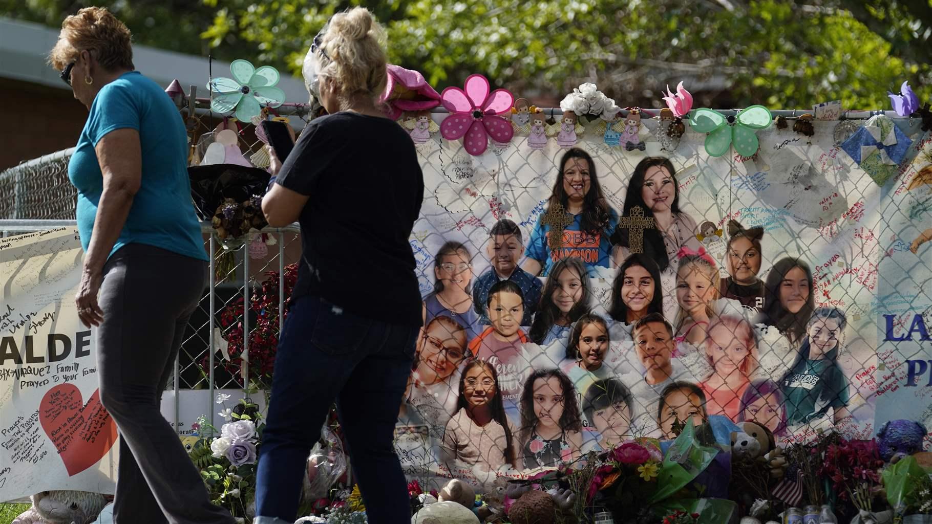 Visitors walk past a make-shift memorial at Robb Elementary School, Tuesday, Sept. 6, 2022, in Uvalde, Texas. Students are returning to campuses for the first time since the shootings at Robb Elementary where two teachers and 19 students were killed. (AP Photo/Eric Gay) Visitors walk past a make-shift memorial at Robb Elementary School, Tuesday, Sept. 6, 2022, in Uvalde, Texas. Students are returning to campuses for the first time since the shootings at Robb Elementary where two teachers and 19 students were killed. (AP Photo/Eric Gay)