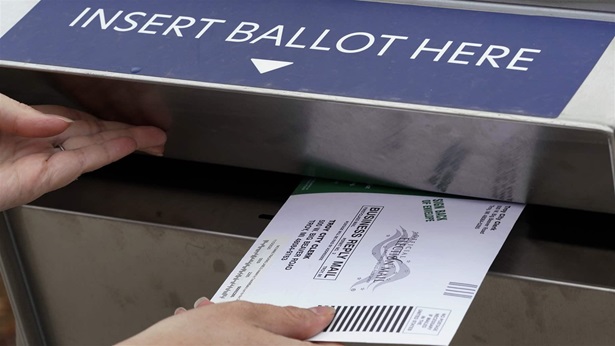 A Michigan voter inserts her absentee voter ballot into a drop box in Troy, Mich. on Oct. 15, 2020. After the 2020 presidential election, former President Donald Trump and his supporters claimed thousands of votes had been cast fraudulently on behalf of dead voters, even naming specific deceased people whose ballots were supposedly counted. But these claims, which spread in many states including Arizona, Virginia, Nevada, Pennsylvania, Michigan and Georgia, were found to be false. (AP Photo/Paul Sancya, File) A Michigan voter inserts her absentee voter ballot into a drop box in Troy, Mich. on Oct. 15, 2020. After the 2020 presidential election, former President Donald Trump and his supporters claimed thousands of votes had been cast fraudulently on behalf of dead voters, even naming specific deceased people whose ballots were supposedly counted. But these claims, which spread in many states including Arizona, Virginia, Nevada, Pennsylvania, Michigan and Georgia, were found to be false. (AP Photo/Paul Sancya, File)