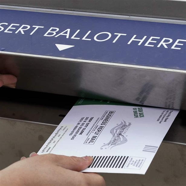 A Michigan voter inserts her absentee voter ballot into a drop box in Troy, Mich. on Oct. 15, 2020. After the 2020 presidential election, former President Donald Trump and his supporters claimed thousands of votes had been cast fraudulently on behalf of dead voters, even naming specific deceased people whose ballots were supposedly counted. But these claims, which spread in many states including Arizona, Virginia, Nevada, Pennsylvania, Michigan and Georgia, were found to be false. (AP Photo/Paul Sancya, File) A Michigan voter inserts her absentee voter ballot into a drop box in Troy, Mich. on Oct. 15, 2020. After the 2020 presidential election, former President Donald Trump and his supporters claimed thousands of votes had been cast fraudulently on behalf of dead voters, even naming specific deceased people whose ballots were supposedly counted. But these claims, which spread in many states including Arizona, Virginia, Nevada, Pennsylvania, Michigan and Georgia, were found to be false. (AP Photo/Paul Sancya, File)