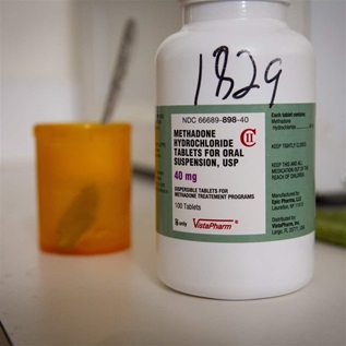 A prescription bottle of methadone on a counter