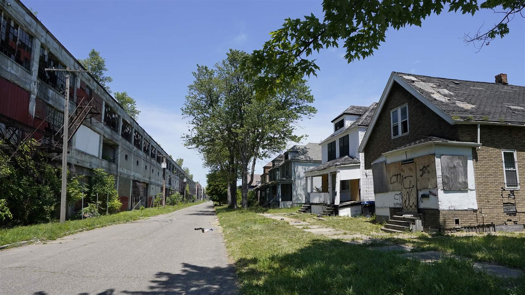 Exterior of the Packard Plant, left, next to boarded up houses on Detroit&#39;s east side, Thursday, June 30, 2022. The factory built in the early 1900s turned out high-end cars into the 1950s. It was considered one of the city&#39;s automotive jewels, but now is among the nation&#39;s most notorious examples of urban blight. Parts of the 3.5 million-square-foot, 40-acre Packard plant complex will be demolished by the year&#39;s end. (AP Photo/Carlos Osorio)