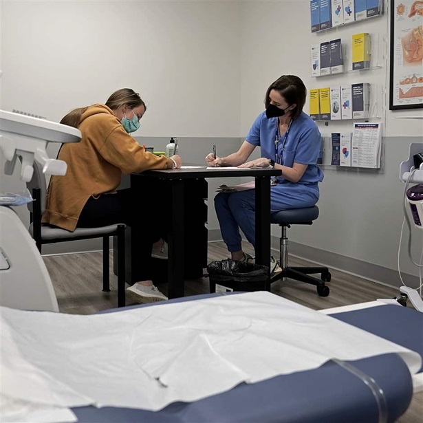 Dr. Elizabeth Brett Daily talks with patient Haley Ruark about the medical abortion process at a Planned Parenthood clinic Wednesday, Oct. 12, 2022, in Kansas City, Kan. (AP Photo/Charlie Riedel)