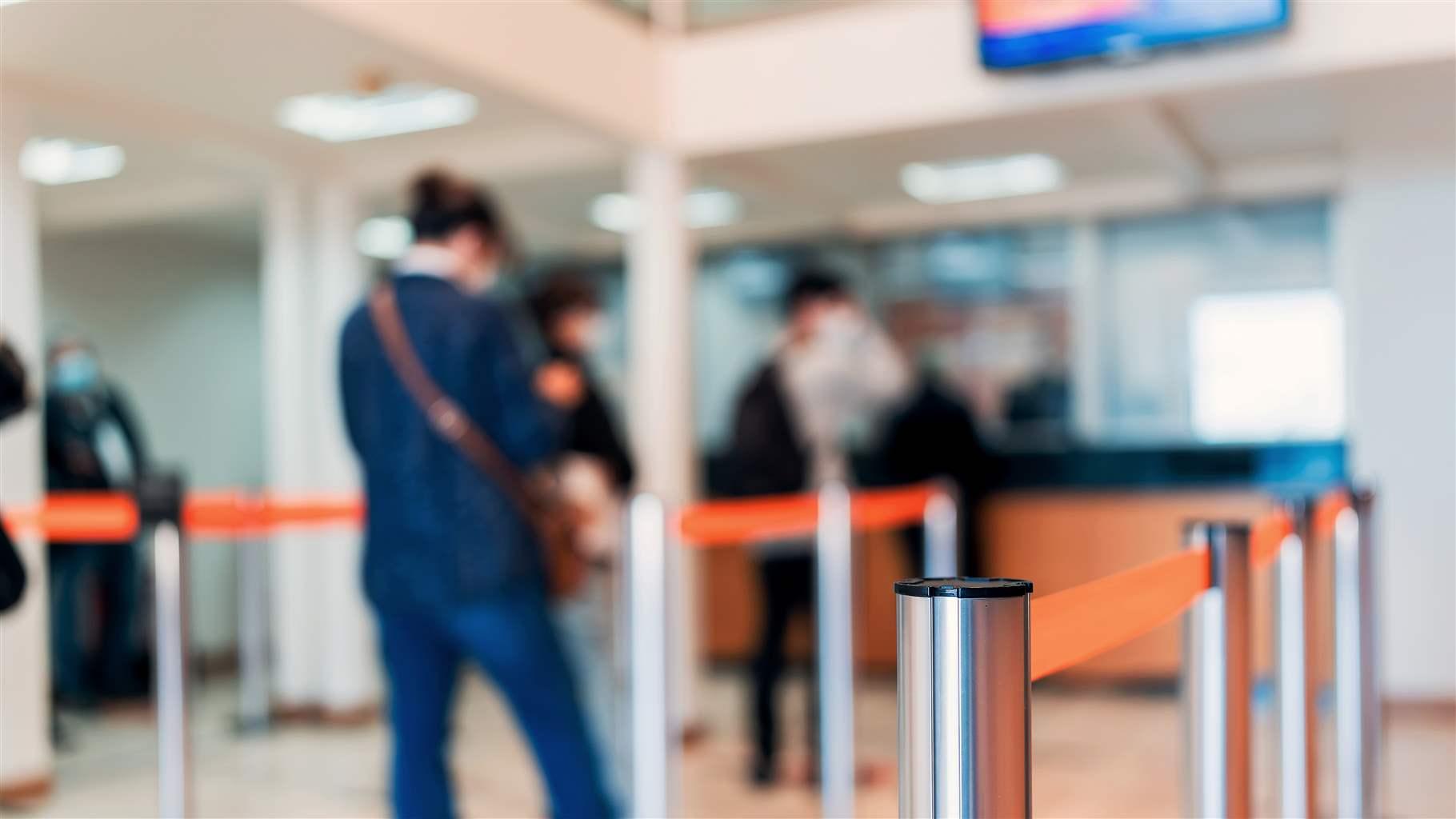 row of people to the bank teller cashier defocused background