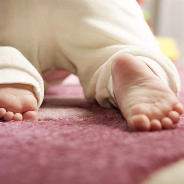 Little baby crawling on the pink carpet. Home visiting visit parent mother