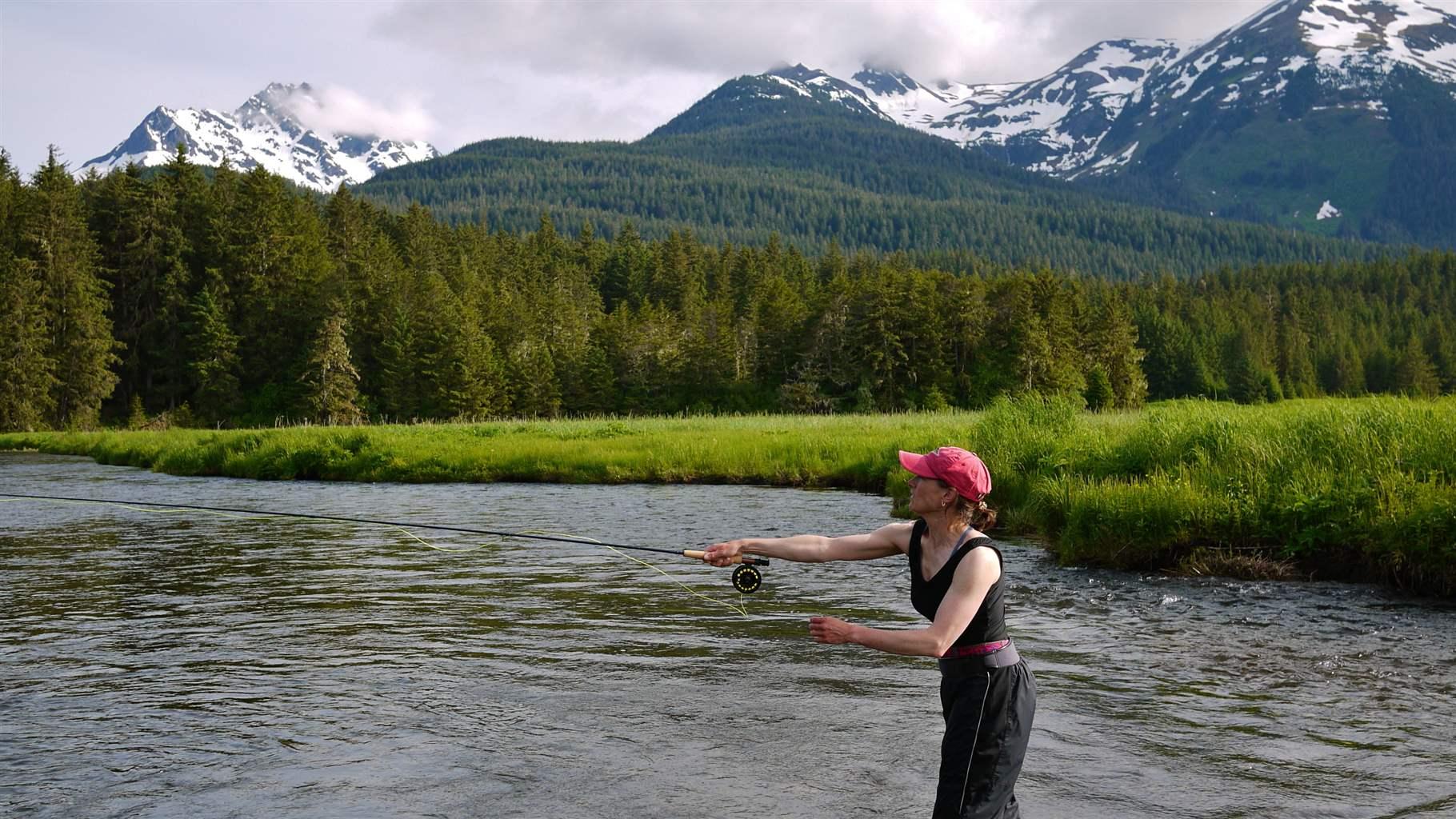 A woman fly-fishes on Admiralty Creek in the Tongass National Forest. Streams and rivers in the forest support large fish populations.
