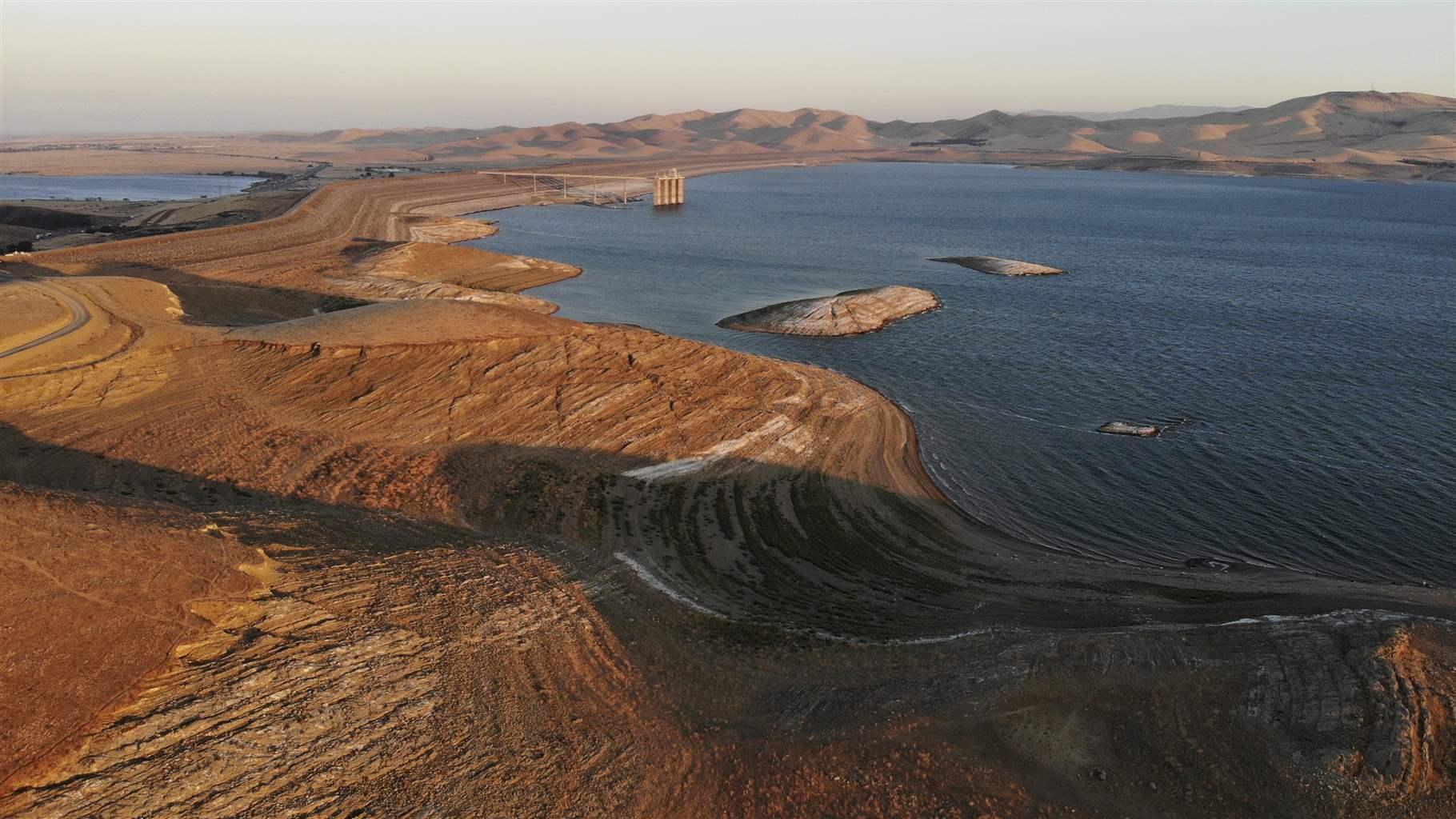 Water levels are low at San Luis Reservoir, which stores irrigation water for San Joaquin Valley farms, in Gustine, Calif., Sept. 14, 2022. As climate change brings hotter temperatures and more severe droughts, cities and states around the world are facing water shortages as lakes and rivers dry up.  (AP Photo/Terry Chea)