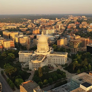 Aerial view of City of Madison. The capital city of Wisconsin from above. Drone flying over Wisconsin State Capitol in downtown. Sunny morning, sunrise (sunset), sunlight, summertime