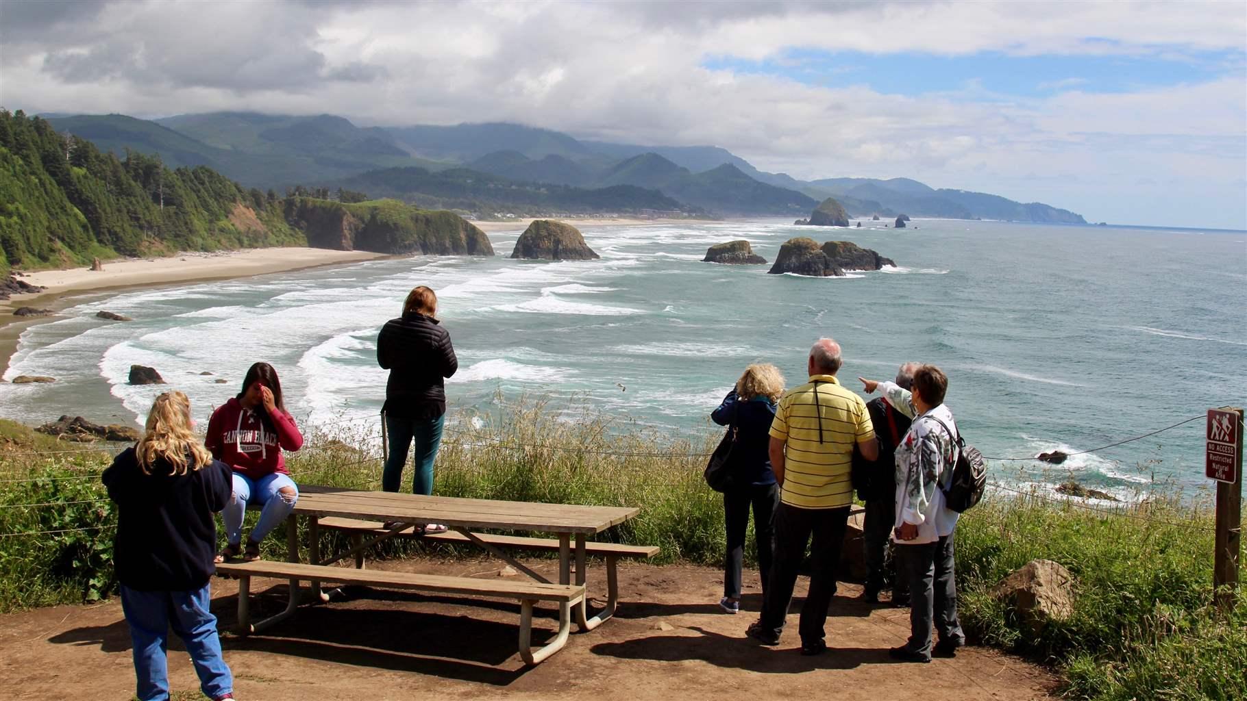 Oregon coast visitors scan for wildlife from the Ecola Point overlook.