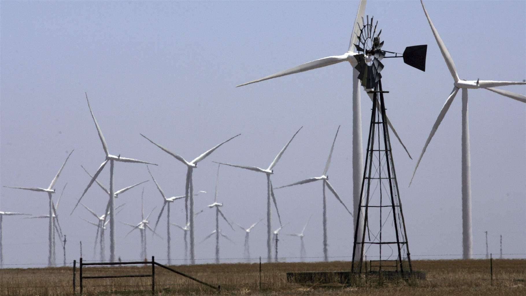 A cattleman’s windmill near a wind farm in rural Potter County, Texas. Wind farms have boosted rural economies in the central U.S. A cattleman’s windmill near a wind farm in rural Potter County, Texas. Wind farms have boosted rural economies in the central U.S.