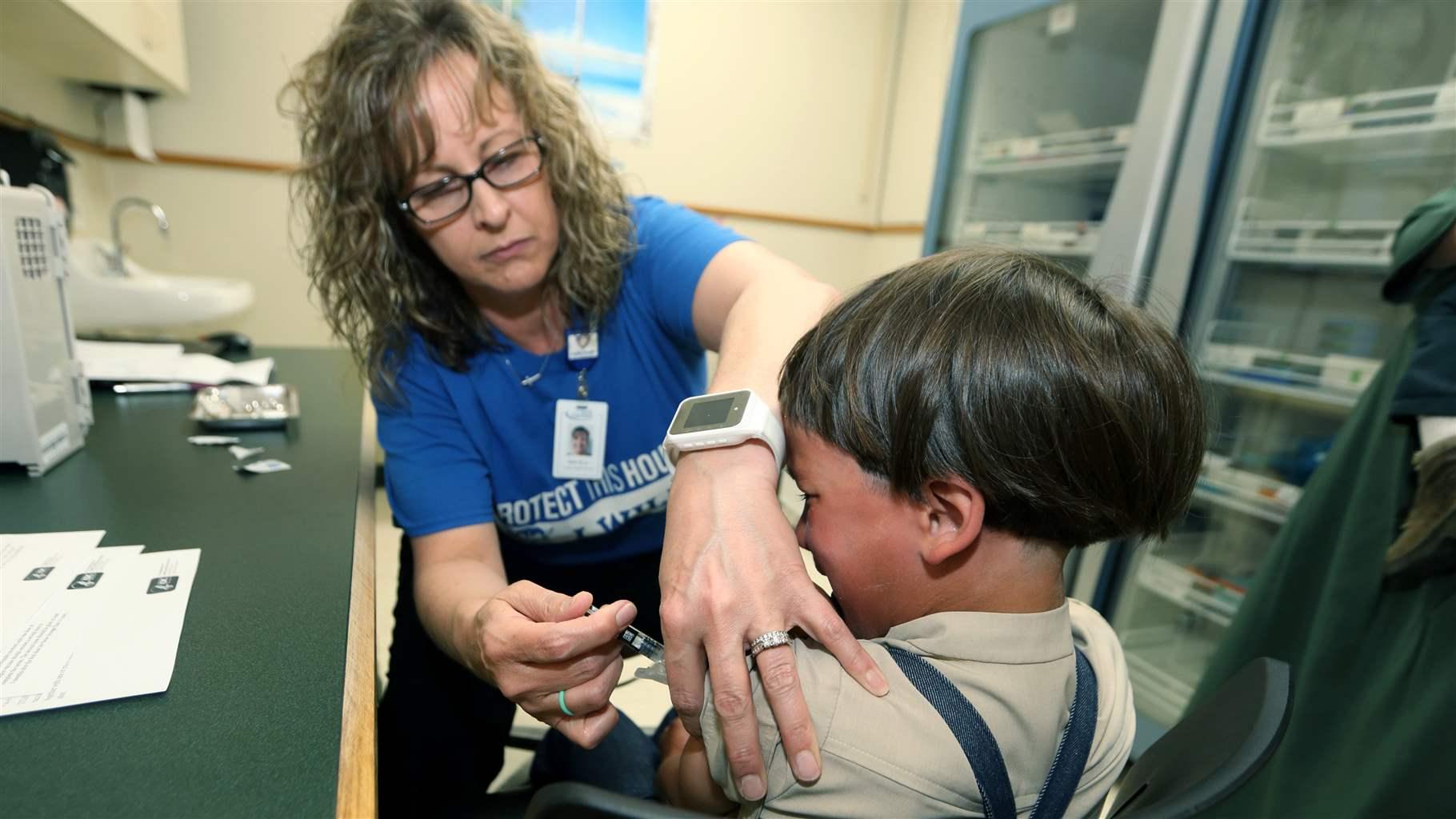 A registered nurse and immunization outreach coordinator with the Knox County Health Department, administers a vaccination to a kid at the facility in Mount Vernon, Ohio, Friday May 17, 2019. In a report issued Wednesday, Nov. 23, 2022, the World Health Organization and the U.S. Centers for Disease Control and Prevention say measles immunization has dropped significantly since the coronavirus pandemic began, resulting in a record high of nearly 40 million children missing a vaccine dose last year. (AP Photo/Paul Vernon, File)