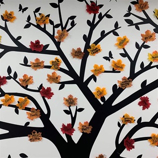 In one of Recovery Point's community rooms, a tree is painted on the wall. On it, the women have hung autumn leaves they collected outside. 