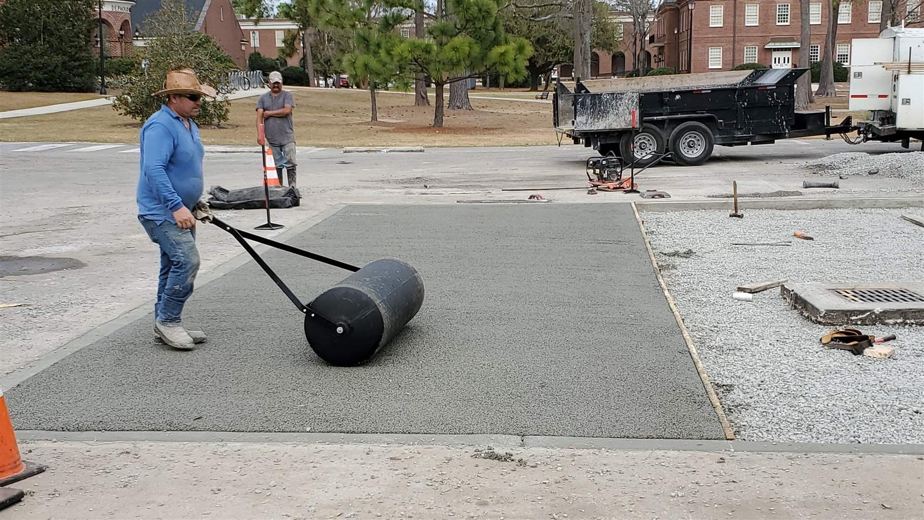 Workers replace sections of a parking lot at the University of North Carolina Wilmington (UNCW) with permeable pavement that allows rainfall to seep into the ground to reduce stormwater runoff. 