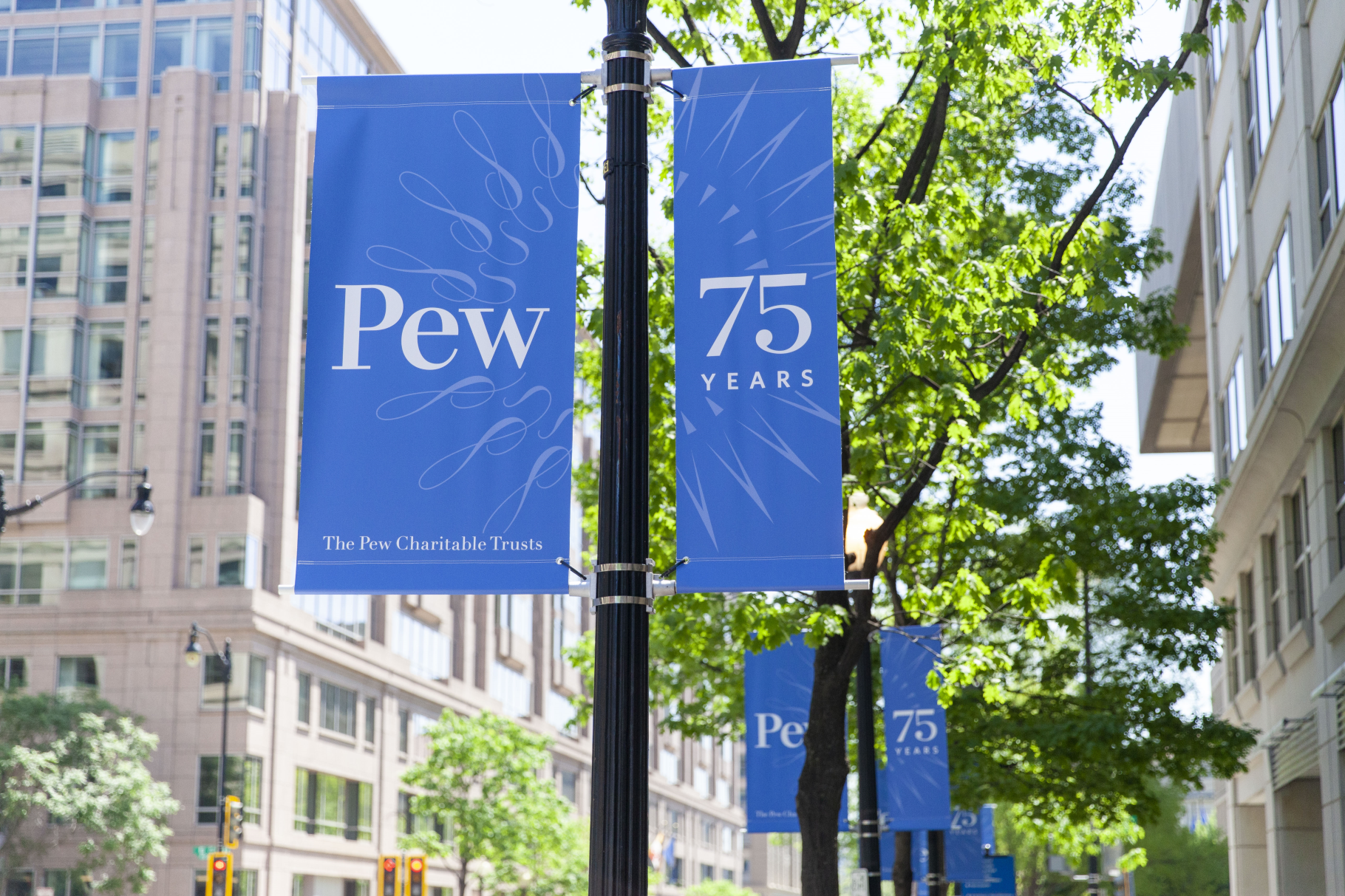 Commemorative Pew 75th Anniversary banners displayed on 9th street in Washington, DC. 
