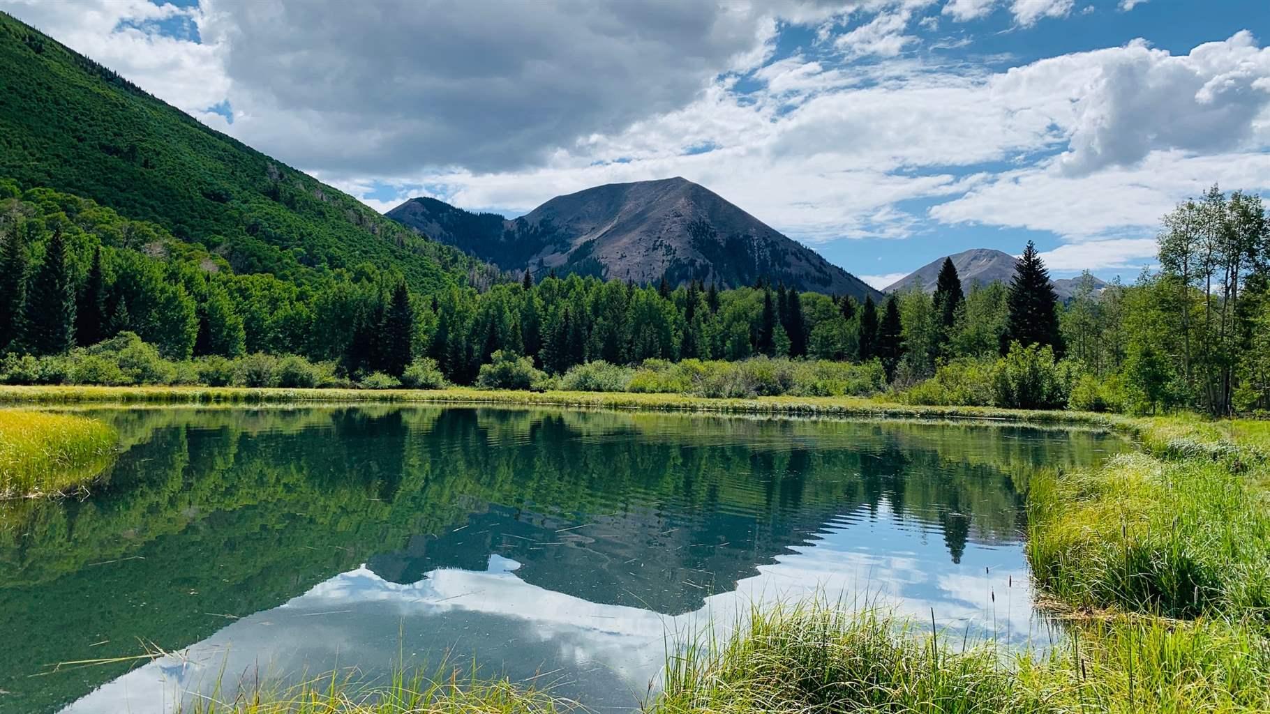 The peaks of the La Sal Mountains rise above Warner Lake in the Manti-La Sal National Forest east of Moab, Utah.
