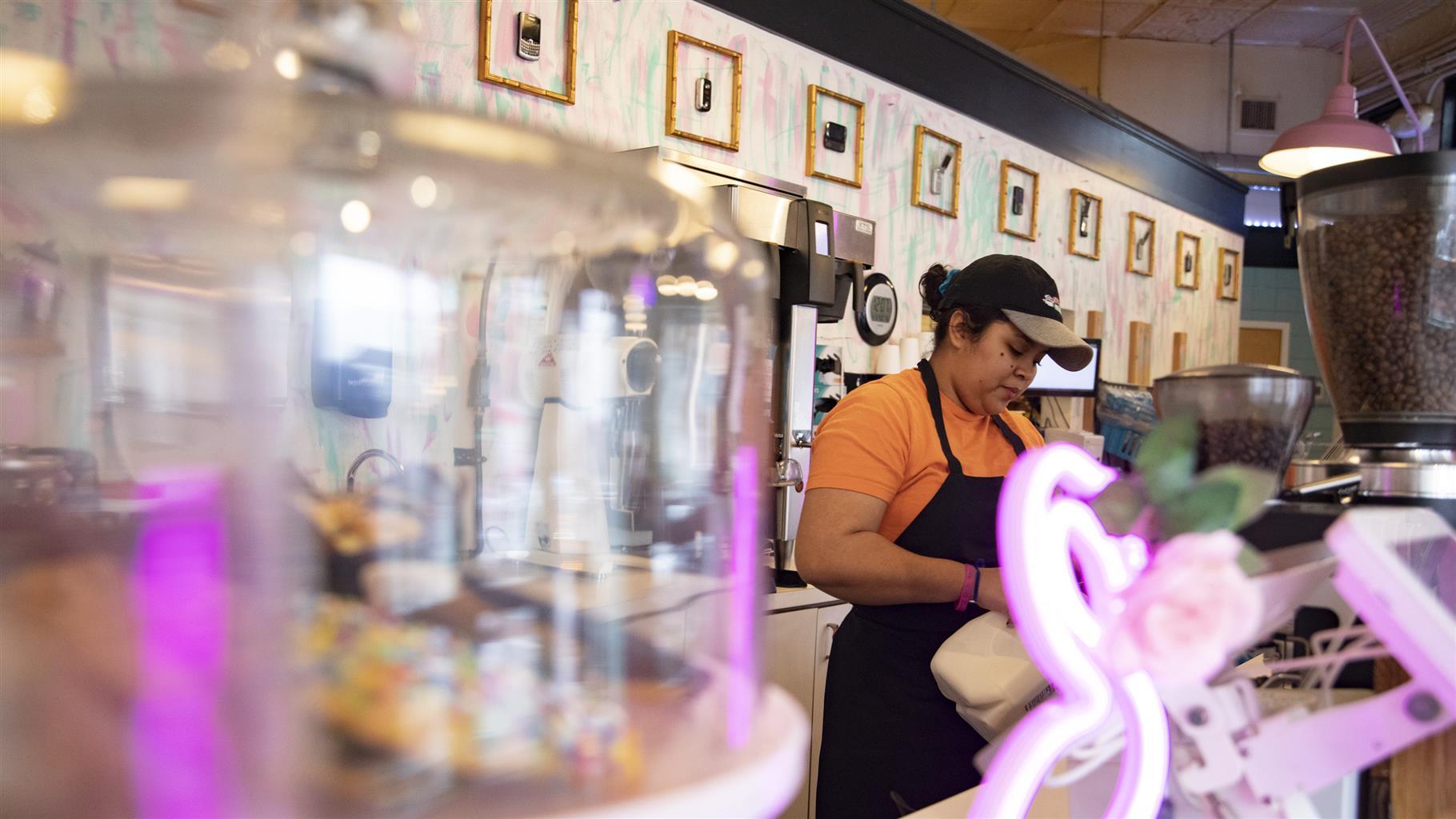 Tatiana Contreras, manager of Call Your Mother bakery in the Barracks Row community, prepares coffee on January 3, 2023 in Washington, DC. Barracks Row is a residential neighborhood filled with local business and restaurants, and is named after the oldest Marine corps in the nation.
