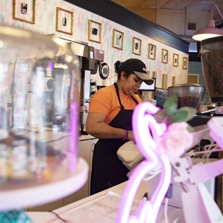 Tatiana Contreras, manager of Call Your Mother bakery in the Barracks Row community, prepares coffee on January 3, 2023 in Washington, DC. Barracks Row is a residential neighborhood filled with local business and restaurants, and is named after the oldest Marine corps in the nation.