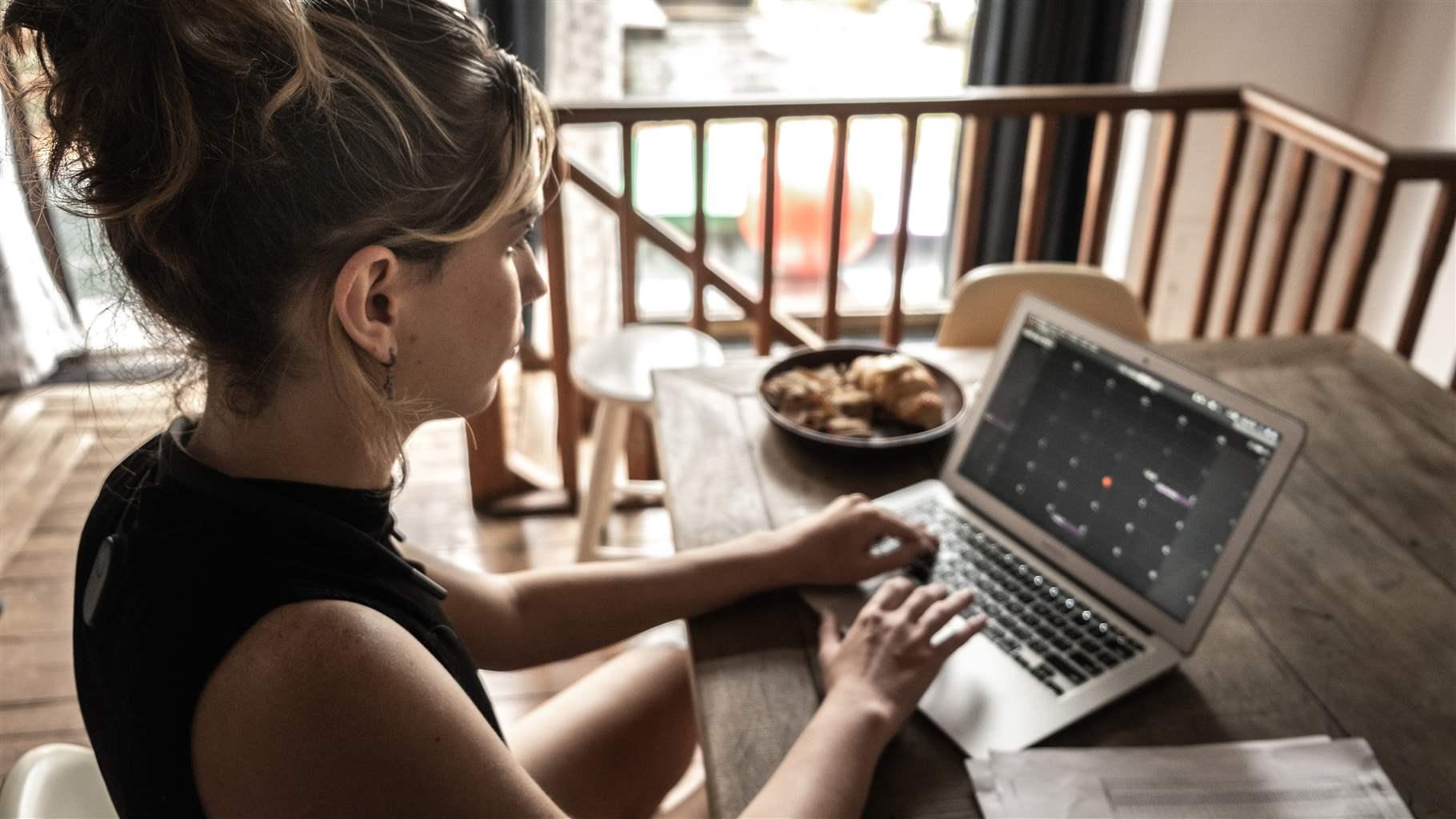 Young woman using laptop working at home