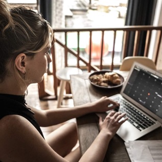 Young woman using laptop working at home