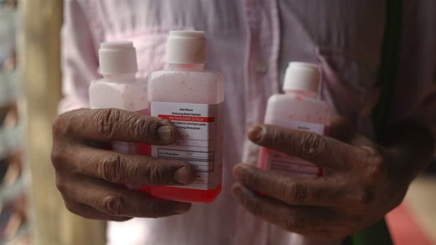 A man receives three bottles of diluted methadone syrup to take home at Ar-Rahman&#39;s mosque, in Kuala Lumpur, Malaysia, on February 16, 2012. (Rahman Roslan/The New York Times)