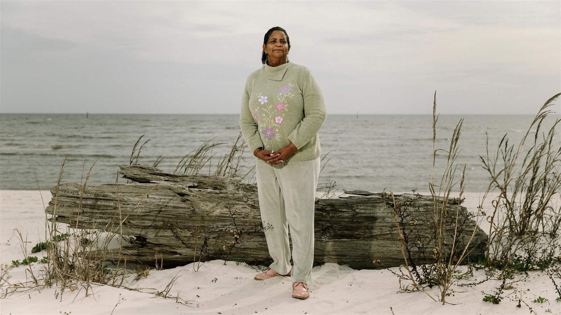 Environmental justice advocate Katherine Egland stands on a beach in her home state of Mississippi. 