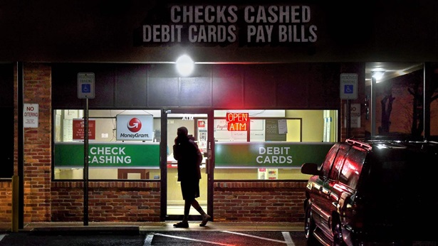 A customer leaves a payday loan store on Frederick Rd. in Gaithersburg, Maryland.