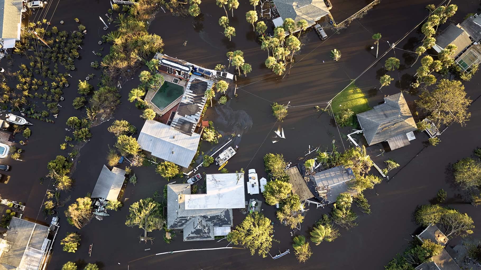 Hurricane Ian flooded houses in Florida residential area. Natural disaster and its consequences.