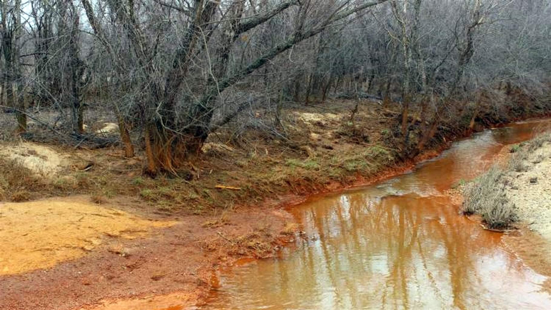 A creek bed with an orange tint from acid runoff