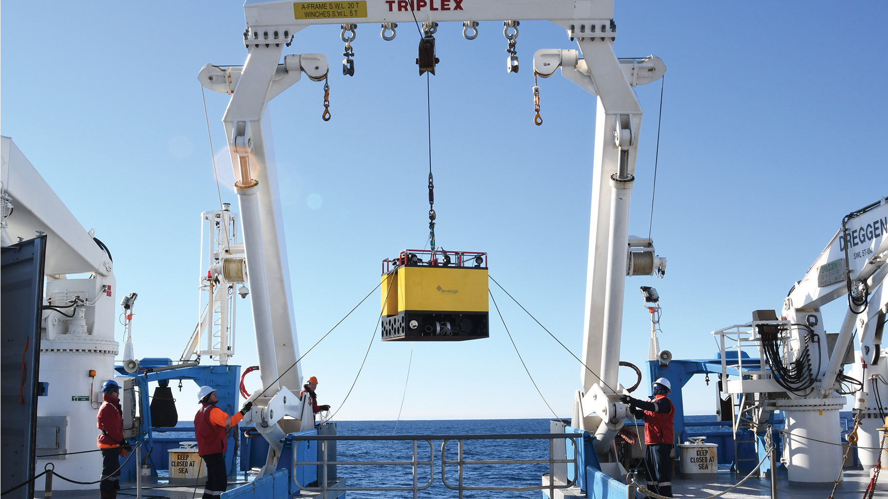 A device known as a KOMBI, here being lowered into the water, will sit on the seafloor for a year measuring changes in krill presence using deep-sea cameras and echosounders.
